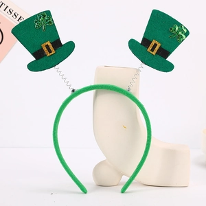 Detail of St. Patrick's Day headband with green felt mini hats and shamrock springs