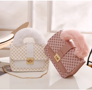 Detail of plush faux fur handle and geometric dot texture on stylish women's mini square bags