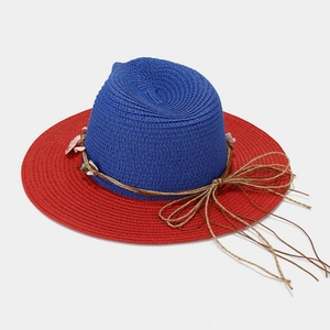 Panama straw hat with navy blue crown, red brim, and seashell trim for seaside vacation