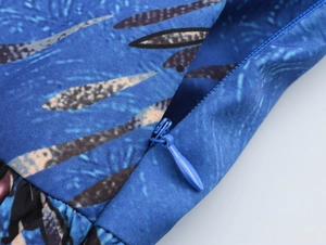 Macro detail of high-quality invisible zipper on blue patterned resort style maxi skirt