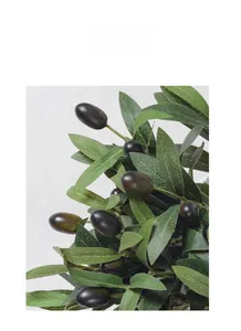 Close-up of realistic artificial olive branch with green leaves and dark purple fruits