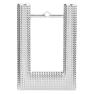 Macro shot of silver stainless steel rectangular pendant with textured dot pattern surface