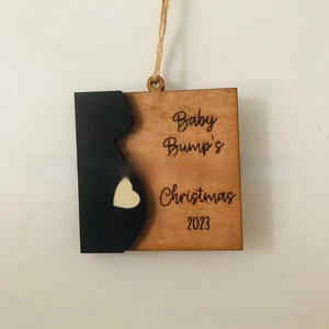 Detail of wooden Baby Bump's First Christmas ornament with pregnant silhouette