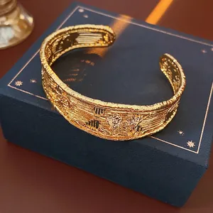 Elegant 18k gold plated open cuff bracelet with mesh texture on a dark jewelry box