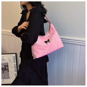 Detail of pink canvas bag with black butterfly buckle and trendy pleated texture