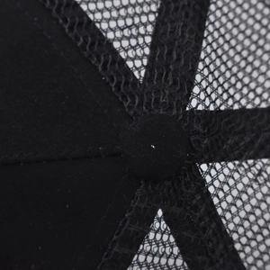Macro shot of black trucker hat top with breathable mesh and premium stitching detail