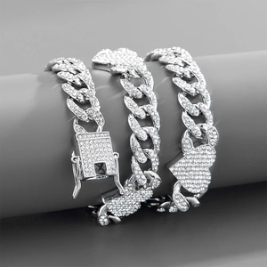 Detail of silver Cuban link bracelet with iced-out heart pendant and square clasp