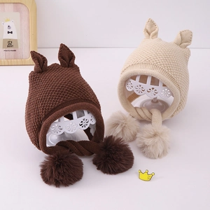Cozy knit baby winter earflap hat with cute ears and fluffy pom poms for cold weather