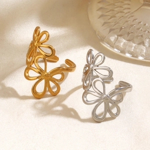 Fashionable floral hollow open rings in gold and silver finish on silk background