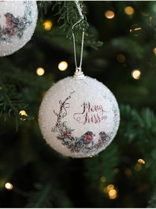 Close-up of a white glitter Christmas ball with robin birds and Merry Kiss me text