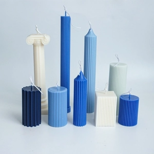 Various fluted cylindrical and square plastic candle molds for DIY aromatherapy candles