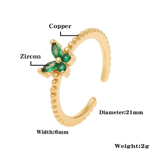 Detail of gold flower ring with green zircon stones, copper material and dimensions