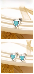 Detail showing heart-shaped blue zircon earrings with silver screw back titanium steel studs