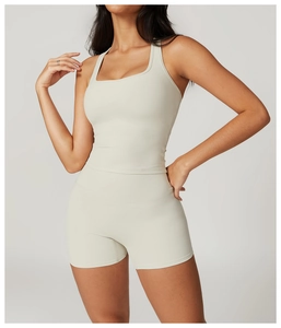 Close-up of beige high-waist fitness shorts and square neck sports top on a model