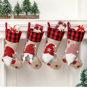 Set of four burlap Christmas stockings with 3D gnomes hanging on a white fireplace