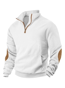 Detail of white quilted sweatshirt with brown suede elbow patches and zipper trim