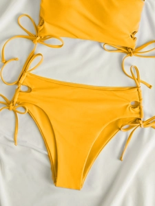 Detailed view of bright yellow high waist bikini bottom with side drawstring tie details