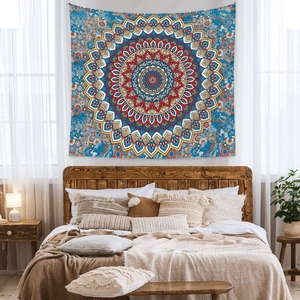 Bohemian mandala tapestry with blue and yellow patterns hanging over a bedroom bed