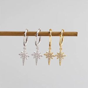 Detail of S925 sterling silver star drop earrings in gold and silver finishes