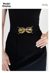 Detail of elastic waist belt with vintage gold crane and pine buckle on black dress