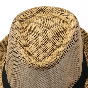 Detailed top view showing breathable hollow mesh weave and ribbon on straw sun hat