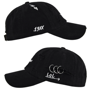 Detailed side view of distressed black cotton baseball cap with silver metal rings and embroidery