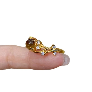 Vintage gold plated tiger eye open ring with zircon floral branch design on finger