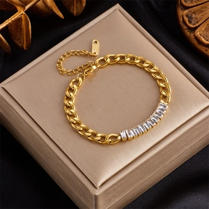 Detailed view of golden stainless steel curb chain bracelet with sparkling zircon inlay