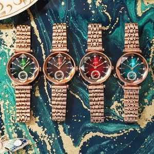 Luxury rose gold women's steel watches with diamond markers on marble background