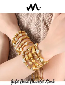 Detail of gold-plated multi-layer beaded bracelet with butterfly and heart charms