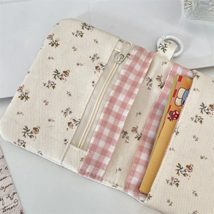 Detail view of floral corduroy card wallet showing inner zipper and card slots