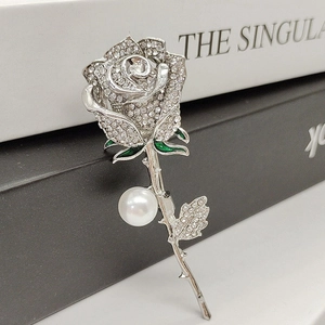 Elegant rose brooch with silver petals, clear crystals, green enamel leaves and pearl