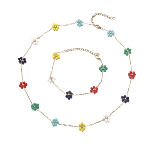 Detail of gold floral jewelry set featuring colorful enamel beads and lobster clasps