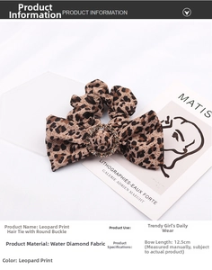 Detail of 12.5cm leopard print bow hair tie featuring a sparkling rhinestone centerpiece