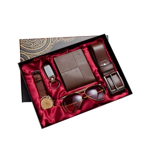 Men's gift set featuring watch, belt, wallet, and sunglasses in a black silk-lined box