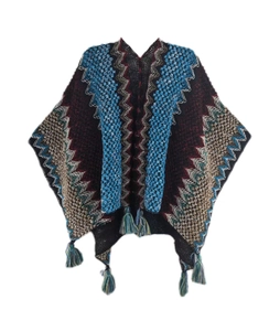 Detail of bohemian knit shawl with zig-zag patterns and decorative fringe tassels