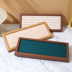 Walnut wood jewelry display trays with emerald green and beige velvet lining inserts