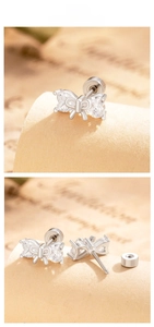 Macro detail of silver bow stud earrings with zircon stones and secure screw-back design