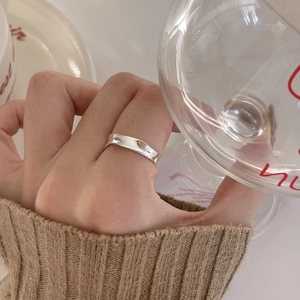 Minimalist S925 sterling silver irregular lava ring shown on finger in cozy setting