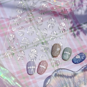 3D embossed ribbon bow nail stickers with pearls shown on various color tips