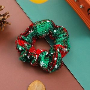 Festive red and green plaid Christmas scrunchie with snowflakes and natural pine cones