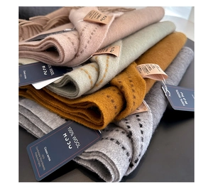 Detail of 100% Australian wool scarves with fringes and elegant stitching details