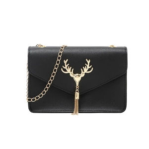 Chic black faux leather crossbody bag with golden deer head and metallic tassels