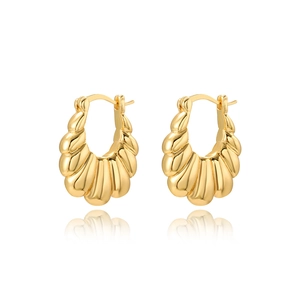 Detailed view of golden 18k croissant hoop earrings with a textured twist design