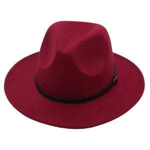 Close-up of wine red wool felt fedora featuring black leather belt and gold buckle