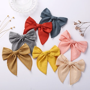 Set of 7 linen cotton bow hair clips for girls in assorted neutral and pastel colors