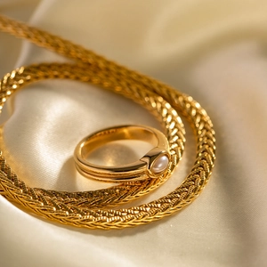Elegant 18k gold plated stainless steel double layer ring with a white pearl on silk fabric