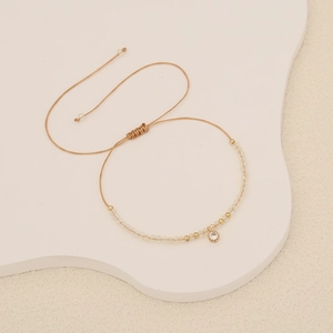 Bohemian woven cord bracelet featuring a crystal zircon charm and adjustable knot closure