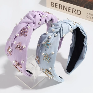 Elegant fabric knot headbands with faux pearls and enamel bowknot charms in blue and purple