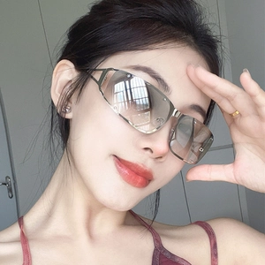 Detail of silver hollow square Y2K sunglasses with gradient lenses and metal frames